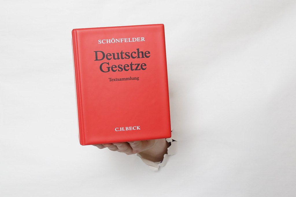 man writing on paper